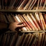 tons of medical records on a shelf in a darkened room