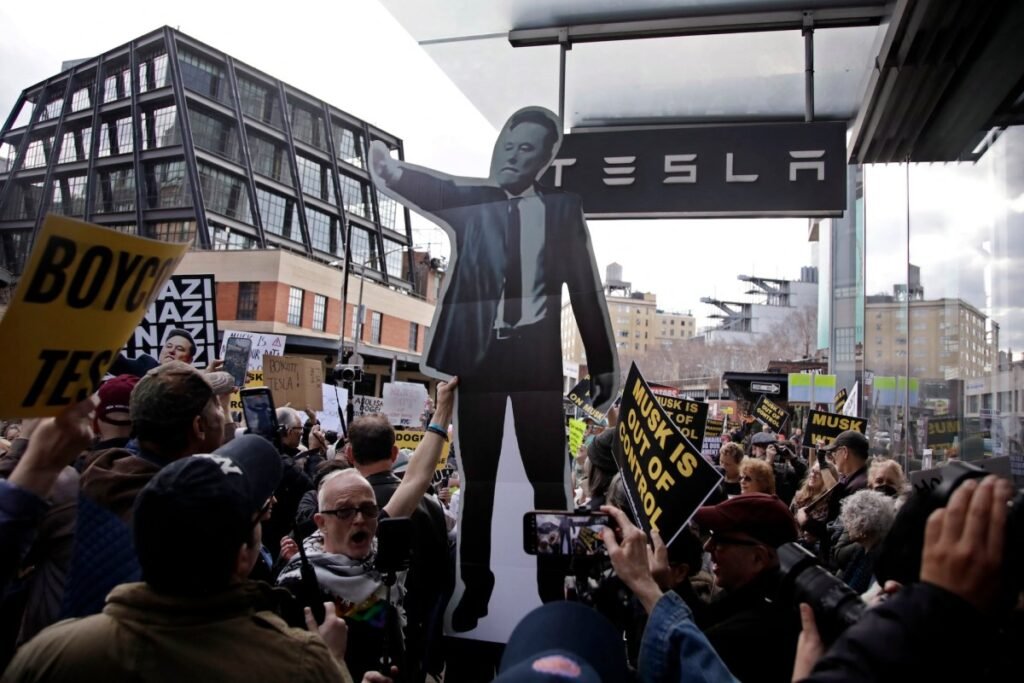 People participate in a "TeslaTakedown" protest against Elon Musk outside of a Tesla dealership in New York, March 1, 2025.