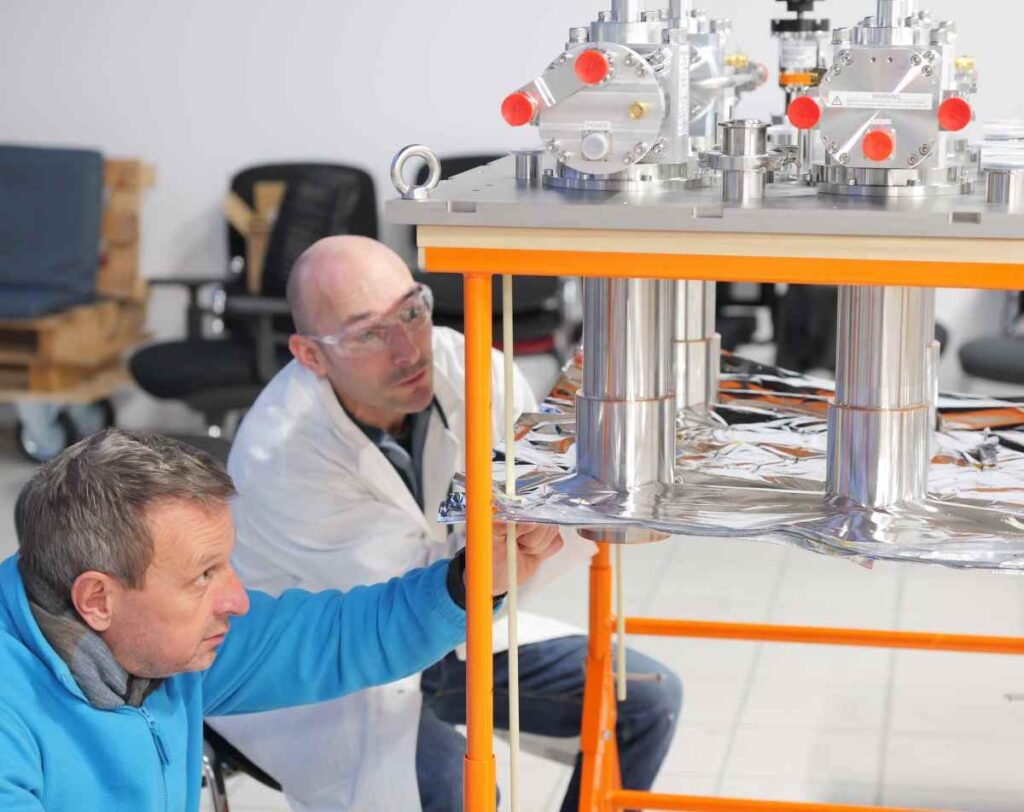 Scientists at Renaissance Fusion examine equipment.
