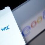 The Wiz logo on a smartphone arranged in