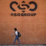 A woman walks by the building entrance of Israeli cyber company NSO Group at one of its branches in the Arava Desert on November 11, 2021 in Sapir, Israel.
