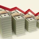 stacks of dollars with down red arrow