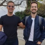 Wasp founders Martin and Matija Sosic standing behind Y Combinator sign