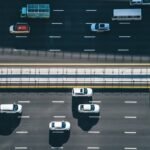 Drone point of view of vehicles on a busy highway.
