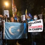 Rahima Mahmut (L), UK director of World Uyghur Congress holds an East Turkestan Flag during the demonstration. On October 1st, various anti-China Diasporas in London came together in solidarity against the Chinese Communist Party.