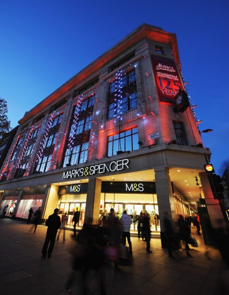 LONDON, ENGLAND - NOVEMBER 26: General view of shoppers walking past the entrance to the Marks & Spencer store on Oxford Street on November 26, 2009 in London, England.