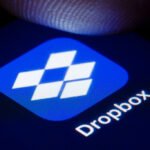 The logo of the file hosting service Dropbox is shown on the display of a smartphone