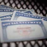 a close up shot of several Social Security cards on a chequered mat.