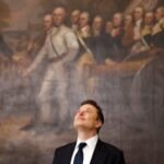 a photo of Elon Musk looking up at the ceiling while standing in front of a historical painting