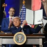 US President Donald Trump displays an executive order on artificial intelligence he signed at the "Winning the AI Race" AI Summit at the Andrew W.