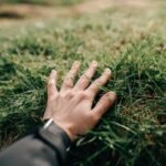 hand touching grass