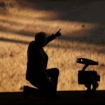 Nvidia founder and CEO Jensen Huang talks to a robot as he speaks during Nvidia Live at CES 2026 ahead of the annual Consumer Electronics Show in Las Vegas, Nevada, on January 5, 2026.