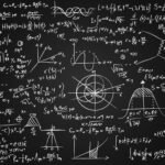 Image of math equations written on a blackboard.