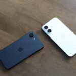 Two Apple iPhone 16e units splayed on table