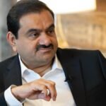 Gautam Adani, chairman of Adani Group, sits during a television interview.