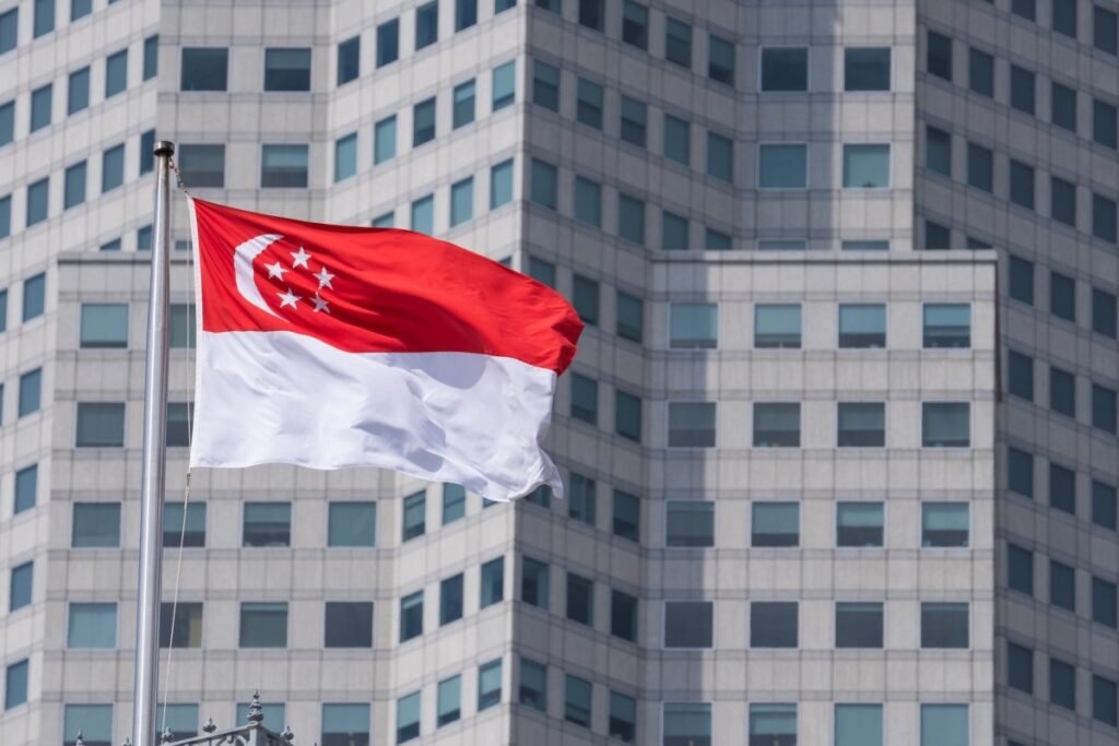 The Singapore flag on top of the parliament building ahead of incoming Prime Minister Lawrence Wong's swearing-in ceremony in Singapore, on Wednesday, May 15, 2024. Wong, Singapore's fourth prime minister since independence, will have to tackle rising cost-of-living concerns, balance US-China tensions and plan for an election after succeeding Lee Hsien Loong. Photographer: Nicky Loh/Bloomberg via Getty Images