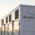 A grid-scale battery stands against a clear sky.