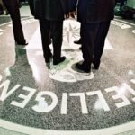 386984 06: President George W. Bush, Central Intelligence Agency Director George Tenet and others stand on the seal of the Agency March 20, 2001 at the CIA Headquarters in Langley, Virginia. Bush toured the facility and met some of the Agency''s employees. (Pool Photo by David Burnett/Newsmakers)