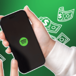 Spotify logo on mobile phone with cartoony dollar bills floating in background