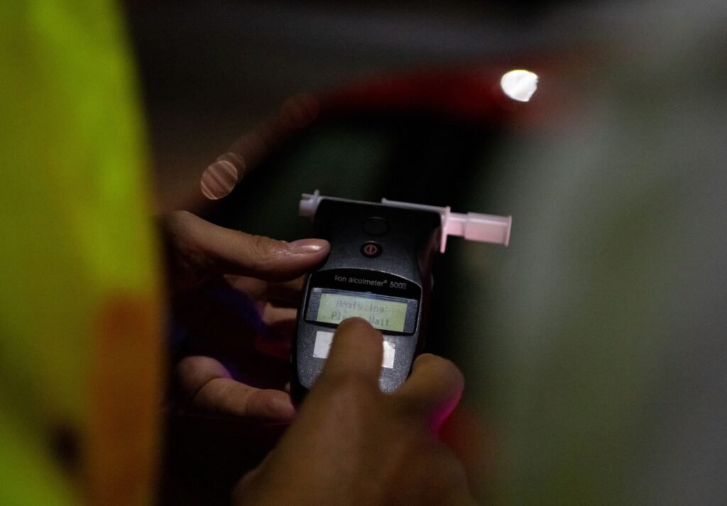 A police officer administers a breathalyser breath alcohol test after stopping a driver, on December 02, 2022 in Bournemouth, England.