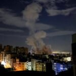 A smoke plume rises following a missile strike on a building in Tehran on March 1, 2026.