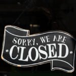 A closed sign in the window of a small business