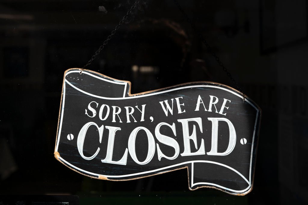 A closed sign in the window of a small business