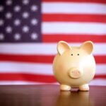 piggy bank in front of american flag. government spending in tech