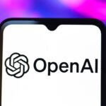 The OpenAI logo is seen displayed on a smartphone screen.