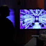 Guests await the beginning of a news conference with U.S. Energy Secretary Jennifer Granholm at the Department of Energy headquarters to announce a breakthrough in fusion research on December 13, 2022 in Washington, DC.