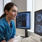 Doctor looking at x-rays from CT-scanner on computer