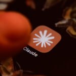 The Claude app icon is displayed on a smartphone screen