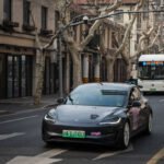Tesla Model 3 vehicle drives on the street on February 27, 2025 in Shanghai, China.