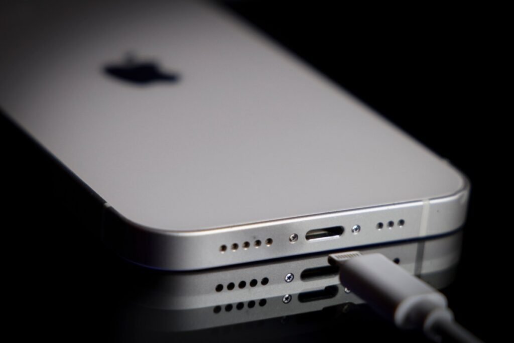 A Apple Lightning port charging cable is seen with with an iPhone.