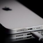 A Apple Lightning port charging cable is seen with with an iPhone.