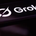 The Grok logo is displayed on a mobile phone screen
