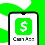 In this photo illustration, the Cash App logo is seen displayed on a smartphone screen.