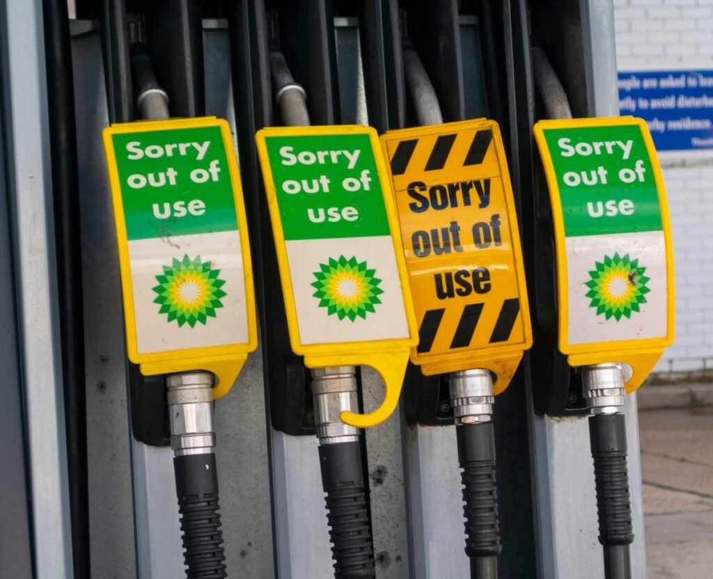 Signs warn drivers that gas pumps are out of order.